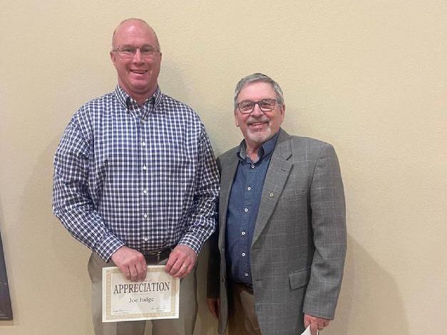 Two men holding a certificate.